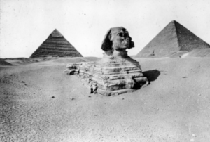 a blurry grayscale photo of the sphinx of giza. it has been edited to have three eyes.
